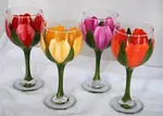 Glass painting designs can be very simple yet provide stunning results as shown here with these spring-inspired tulip wine glasses.